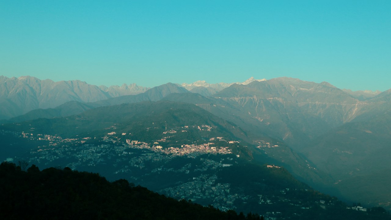 A green Himalayan valley under cloud